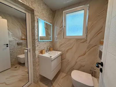 a bathroom with a sink and a toilet at Serenity Suites in Gotse Delchev