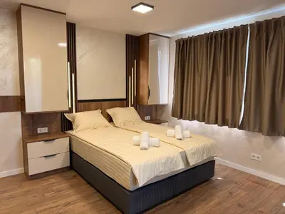 a bedroom with a bed with two towels on it at Serenity Suites in Gotse Delchev