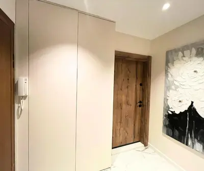 a room with a wooden door and a wall at Cozy Central 1BDR Apartment Sofia near Mall Sofia and metro in Sofia