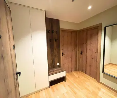 an empty room with a large cabinet and wooden floors at Cozy Central 1BDR Apartment Sofia near Mall Sofia and metro in Sofia