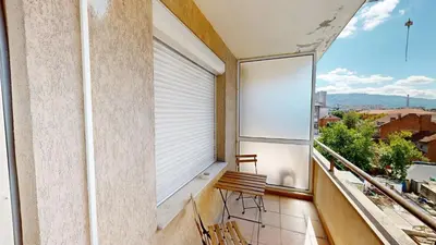 a balcony with a window with a bench on it at Cozy Central 1BDR Apartment Sofia near Mall Sofia and metro in Sofia