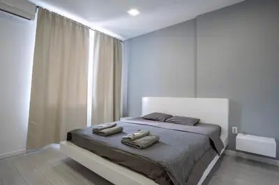 a bedroom with a bed with two towels on it at blueWave.place Sofia in Sofia
