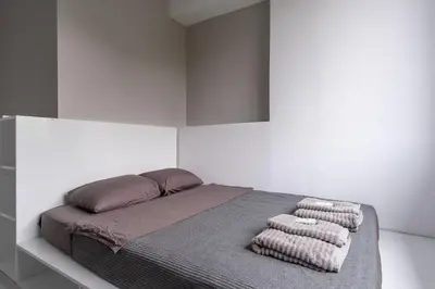 a bedroom with a bed with three pillows on it at blueWave.place Sofia in Sofia