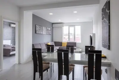 a dining room and living room with a table and chairs at blueWave.place Sofia in Sofia