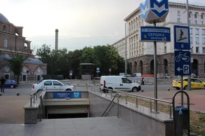 a street with cars driving on a city street at blueWave.place Sofia in Sofia