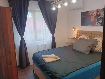 a bedroom with a bed with two pillows on it at Double next to NBU and Merto station, free parking in Sofia