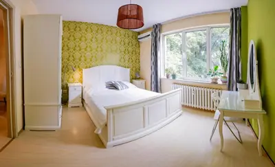 a bedroom with a white bed and a window at TOP central location Sophia apt in Sofia