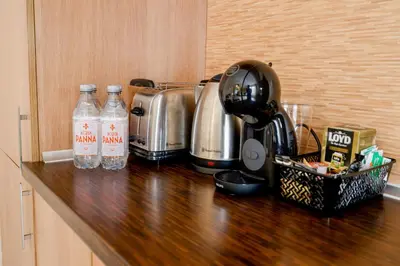 a kitchen counter with bottles of water and a mixer at TOP central location Sophia apt in Sofia