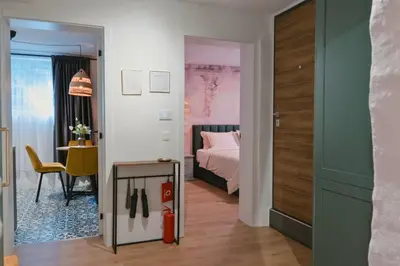 a room with a bedroom with a bed and a table at Quiet & Stylish Apartment in Central Sofia in Sofia