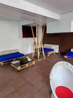 a room with three beds and a table at Green View Apartment in Chepelare