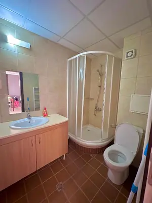 a bathroom with a toilet and a shower and a sink at Green View Apartment in Chepelare