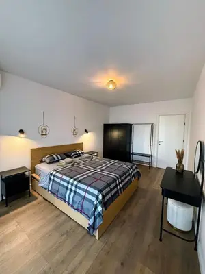 a bedroom with a bed and a desk in it at Modern 2 Bedroom - 2 Baths - Private Garage Free in Center in Sofia