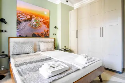 a bedroom with a large bed with white cabinets at Charming Sofia Center Stay for 4 by Flat Mаnager in Sofia