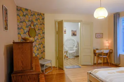 a bedroom with a bed and a mirror and a door at Dream Hill Nest-Boho Vintage Hideaway in Plovdiv