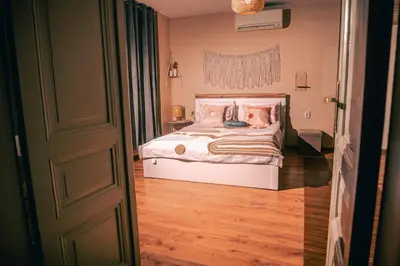 a bedroom with a bed with pink pillows on it at Dream Hill Nest-Boho Vintage Hideaway in Plovdiv