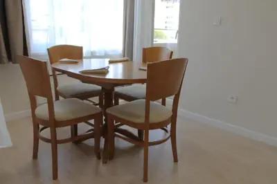 a dining room table with chairs and a wooden table at cosy apartment in Sofia