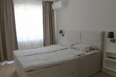a bed in a bedroom with a window at cosy apartment in Sofia
