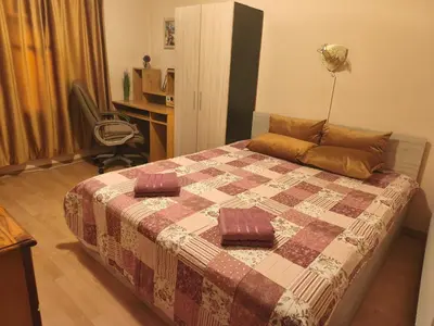 a bedroom with a bed and a desk and a chair at Самостоятелна къща за гости Трояна in Troyan