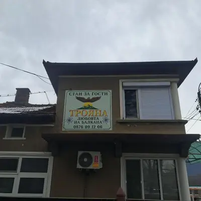 a sign for a restaurant on the side of a house at Самостоятелна къща за гости Трояна in Troyan