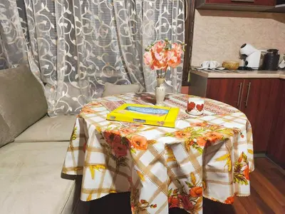 a table with a table cloth on it with a table sidx sidx sidx at Самостоятелна къща за гости Трояна in Troyan