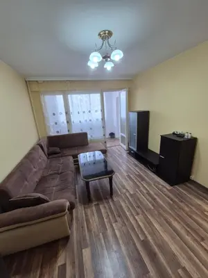 a living room with a couch and a television at Mladost stay apartment in Sofia