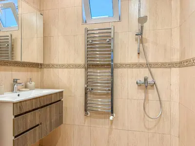 a bathroom with a shower and a sink at Two-Bedroom Central and Cosy Apartment in Plovdiv