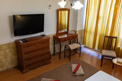 a living room with a television on a dresser at Megy's 3 Bedroom Central Apartment near NDK in Sofia
