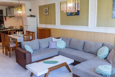 a living room with a couch and a table at Megy's 3 Bedroom Central Apartment near NDK in Sofia