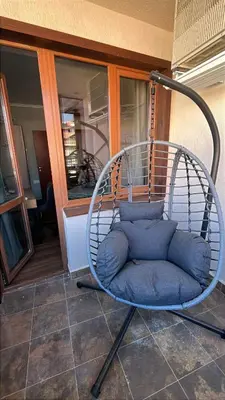 a swing chair sitting on top of a porch at The Bansko Retreat in Bansko