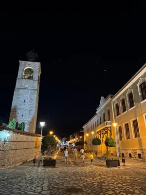 a clock tower in the middle of a street at night at The Bansko Retreat in Bansko