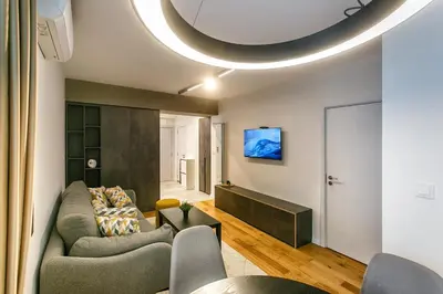 a living room with a couch and a tv at Apartment in Sofia's core - NDK in Sofia