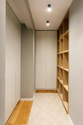 an empty closet with white walls and wooden shelves at Apartment in Sofia's core - NDK in Sofia