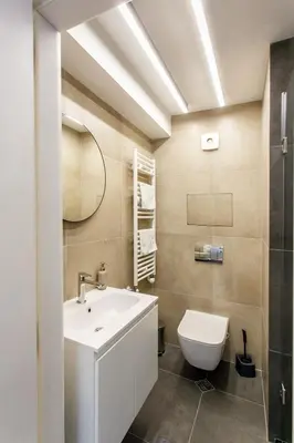 a bathroom with a white sink and a toilet at Apartment in Sofia's core - NDK in Sofia