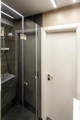 a shower with a glass door in a bathroom at Apartment in Sofia's core - NDK in Sofia