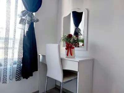 a white desk with a chair and a mirror at Deva Apartments in Sandanski