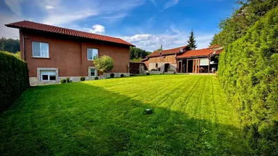 a house with a large lawn in front of it at Къща за Гости Тодор in Shiroki Dol