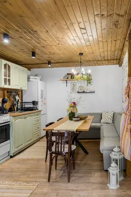 a kitchen and dining room with a table and a couch at Villa YASNA - Art of slow living in Sredno Gradishte