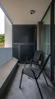 two chairs and a table on a balcony at Fresh & Modern Apartment with Balcony by Flat Mаnager in Sofia