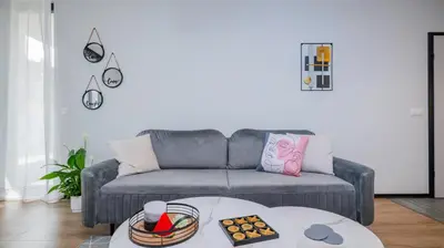 a living room with a couch and a table at Fresh & Modern Apartment with Balcony by Flat Mаnager in Sofia