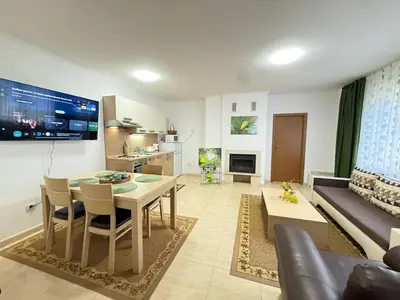 a living room with a table and a couch at Apartment Grand Monastery Pamporovo in Pamporovo