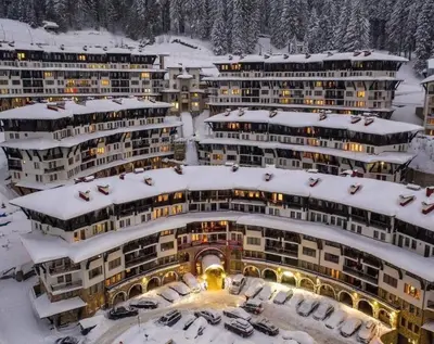 a group of buildings with snow on them at Apartment Grand Monastery Pamporovo in Pamporovo