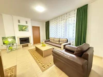 a living room with a couch and a chair at Apartment Grand Monastery Pamporovo in Pamporovo