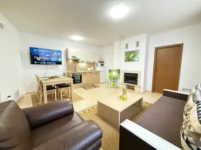 a living room with a couch and a table at Apartment Grand Monastery Pamporovo in Pamporovo