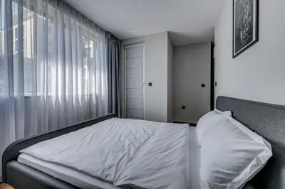 a bedroom with a bed and a window at La Shara Building in Sofia