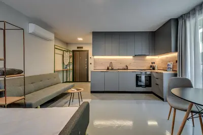 a kitchen and living room with a couch and a table at La Shara Building in Sofia