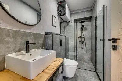 a bathroom with a sink and a shower at La Shara Building in Sofia