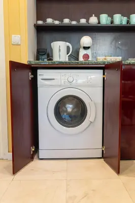 a washing machine under a counter in a kitchen at Megy's 2nd Top Central Room in Sofia