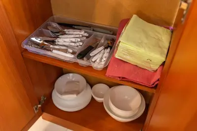 a cupboard with plates and utensils in a room at Megy's 1st Room next to the National Palace of Culture in Sofia