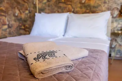 a bed with two towels on top of it at Megy's 1st Room next to the National Palace of Culture in Sofia