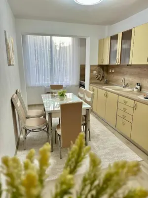 a kitchen with a table and chairs in a kitchen at The Central Suite in Petrich